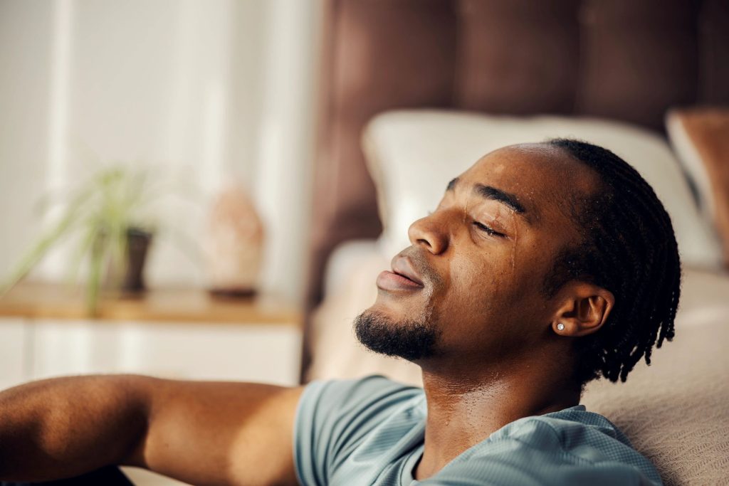 Man resting after intense workout feeling exhausted