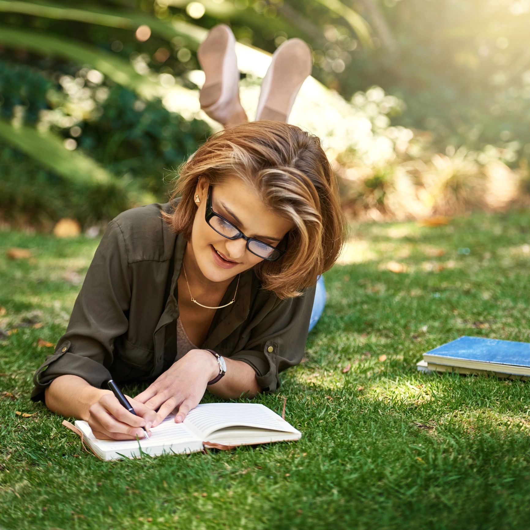 Client writing in a journal outdoors